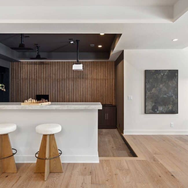 Multi-sport simulators, or “sims,” are being worked into floor plans in new home construction, like this model by Bickimer Homes. An adjacent bar and counter seating extend the experience to an atmosphere of gathering.