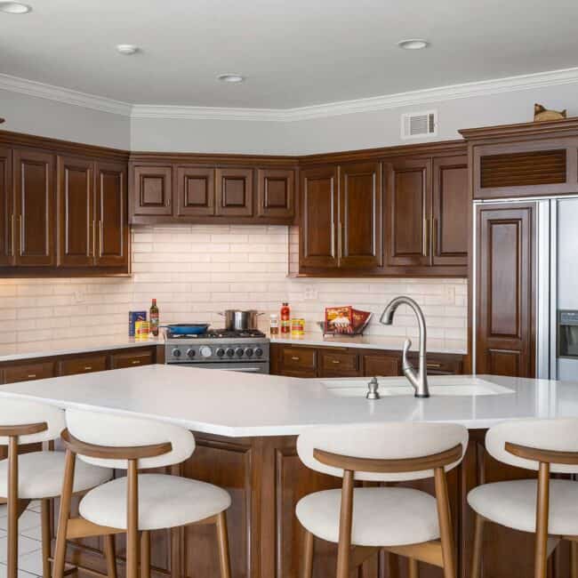 A perfect work triangle: refrigerator to stove to oven to hungry family seated at the island.