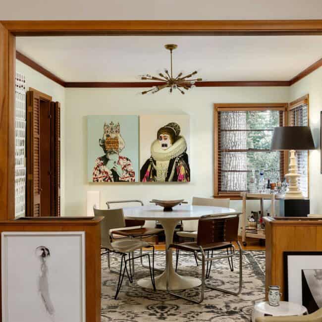 The living room flows into the dining room fluidly blending great art and furnishings. The mid-century ceiling fixture came from Petti’s parents’ home. An Aero Saarinen table is surrounded by Marcel Breuer leather and chrome chairs and Boho Donghia Klismos chairs. A whimsical pair of mixed media works are by Gavin Benjamin. The white lamp was a Barbara Cosgrove design.