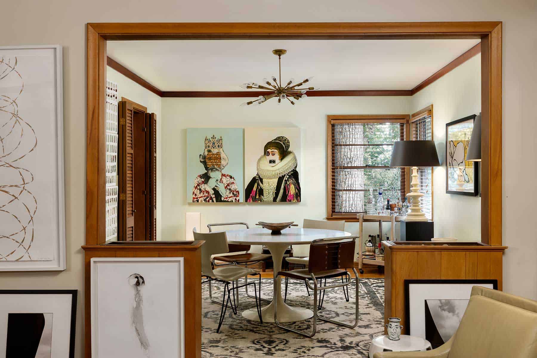 The living room flows into the dining room fluidly blending great art and furnishings. The mid-century ceiling fixture came from Petti’s parents’ home. An Aero Saarinen table is surrounded by Marcel Breuer leather and chrome chairs and Boho Donghia Klismos chairs. A whimsical pair of mixed media works are by Gavin Benjamin. The white lamp was a Barbara Cosgrove design.