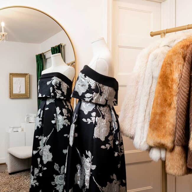 Fancy goods, such as this strapless Laundry by Shelli Segal evening dress and old furs from the ’60s through Y2K, reside in an upstairs room.