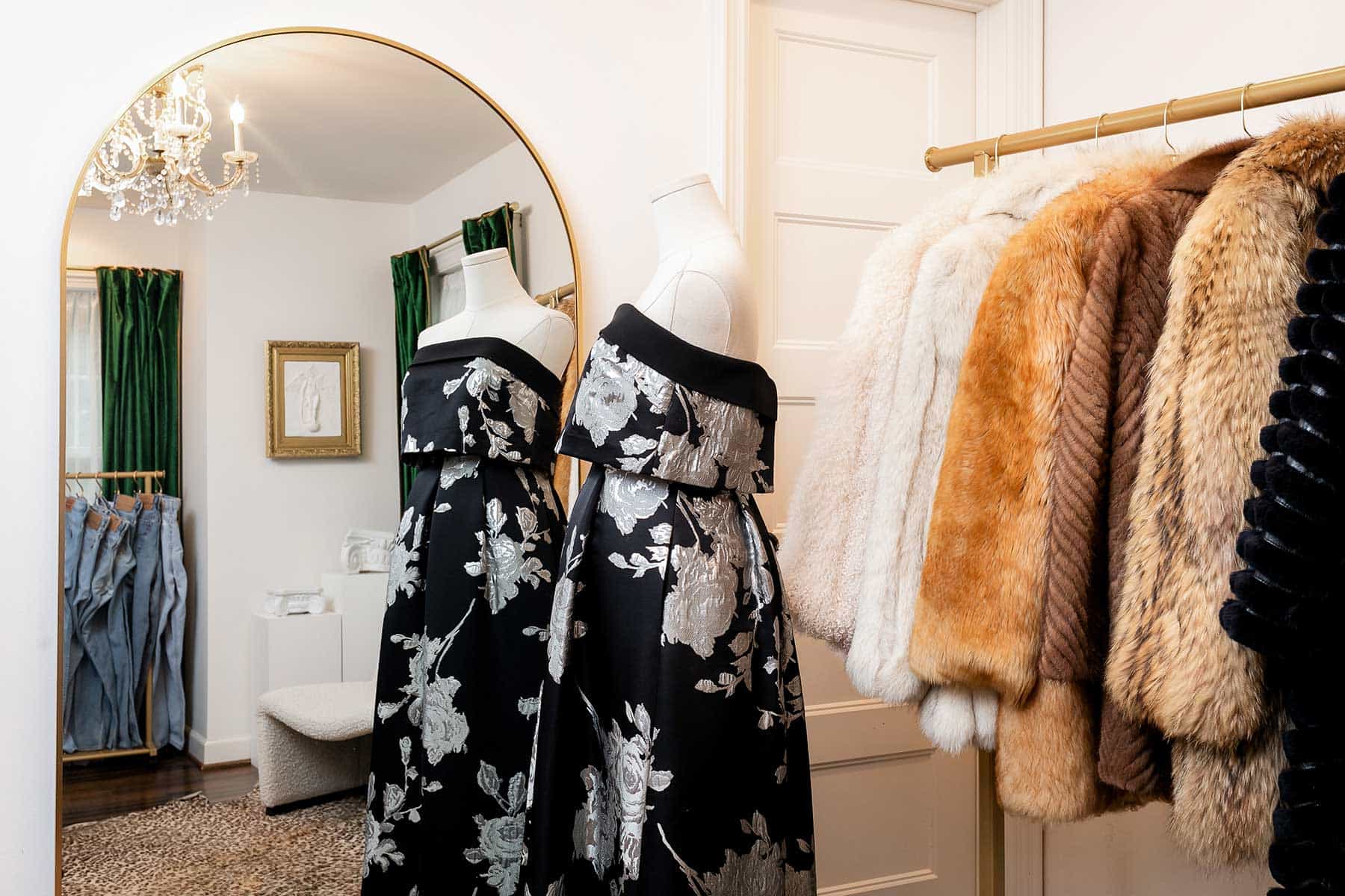 Fancy goods, such as this strapless Laundry by Shelli Segal evening dress and old furs from the ’60s through Y2K, reside in an upstairs room.