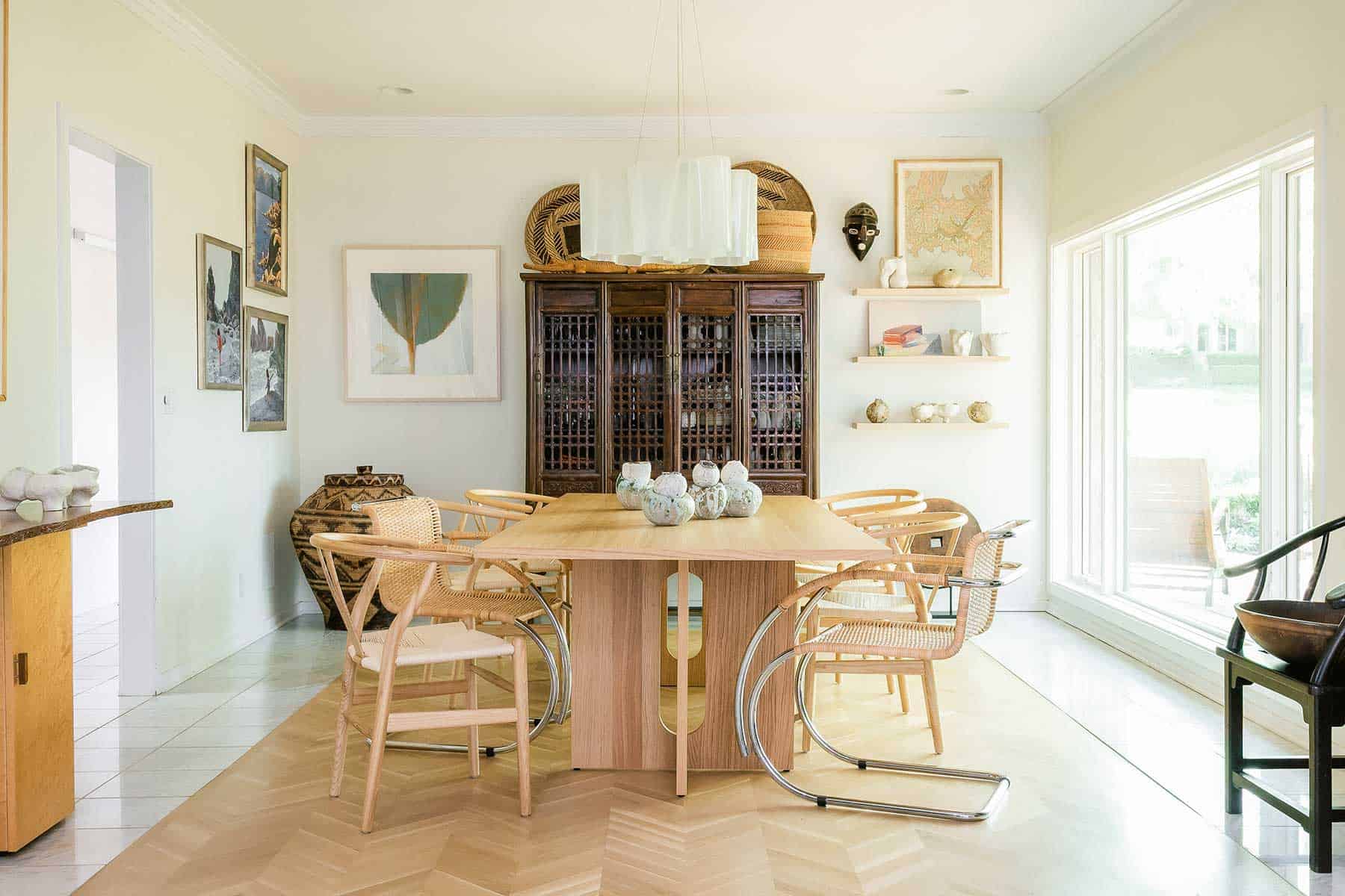 The dining room represents a mix of provenances. African baskets and an antique Chinese case piece set an authentic mood alongside a contemporary dining table by Danielle Siggerud for Audo Copenhagen, from Kanso. It holds Krahn’s nesting vessels, available at Blackbird Collection and Mergers in the Crossroads Art District. The dining chairs are Mies van der Rohe and Hans Wegner. On the left wall are three oil paintings by Krahn of her daughters from 2000. SVB Wood Floors installed the herringbone hardwoods.