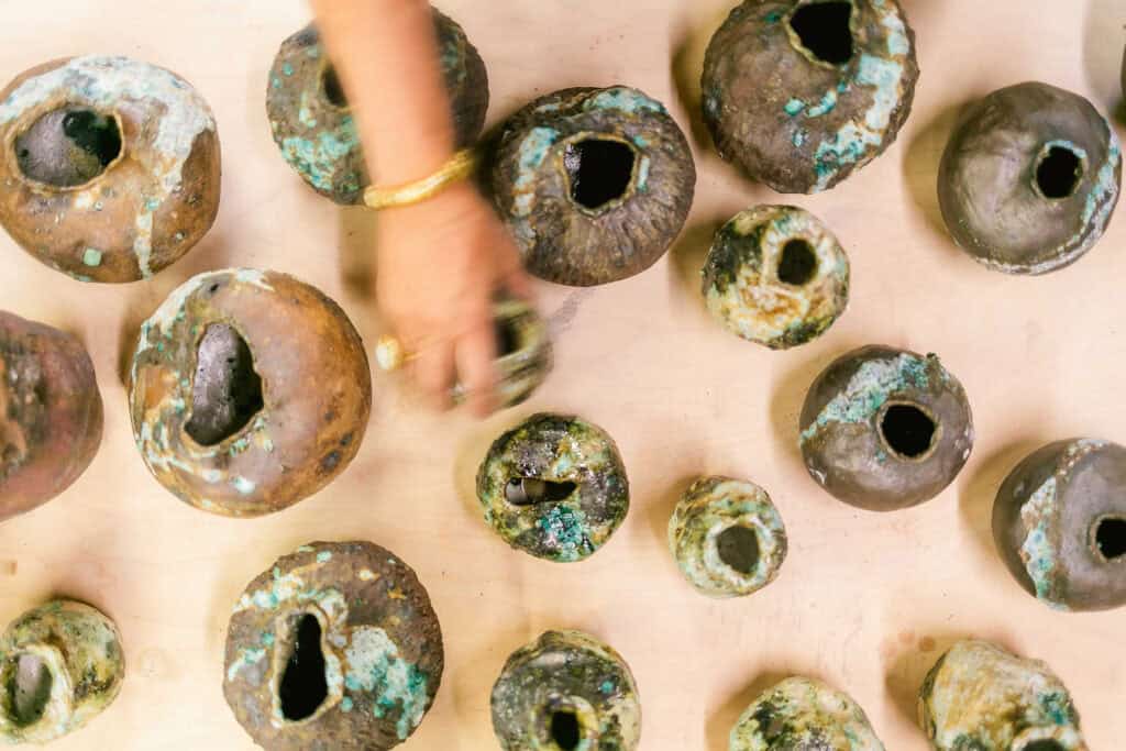 Iron-rich stoneware vessels are treated with handcrafted glaze of foraged minerals and other natural elements from her travels. Krahn’s father designed the gold ring with an opal from Australia, and offered gold, presented to him in a basket filled with nuggets by a friend in Papua New Guinea who owned a gold mine.