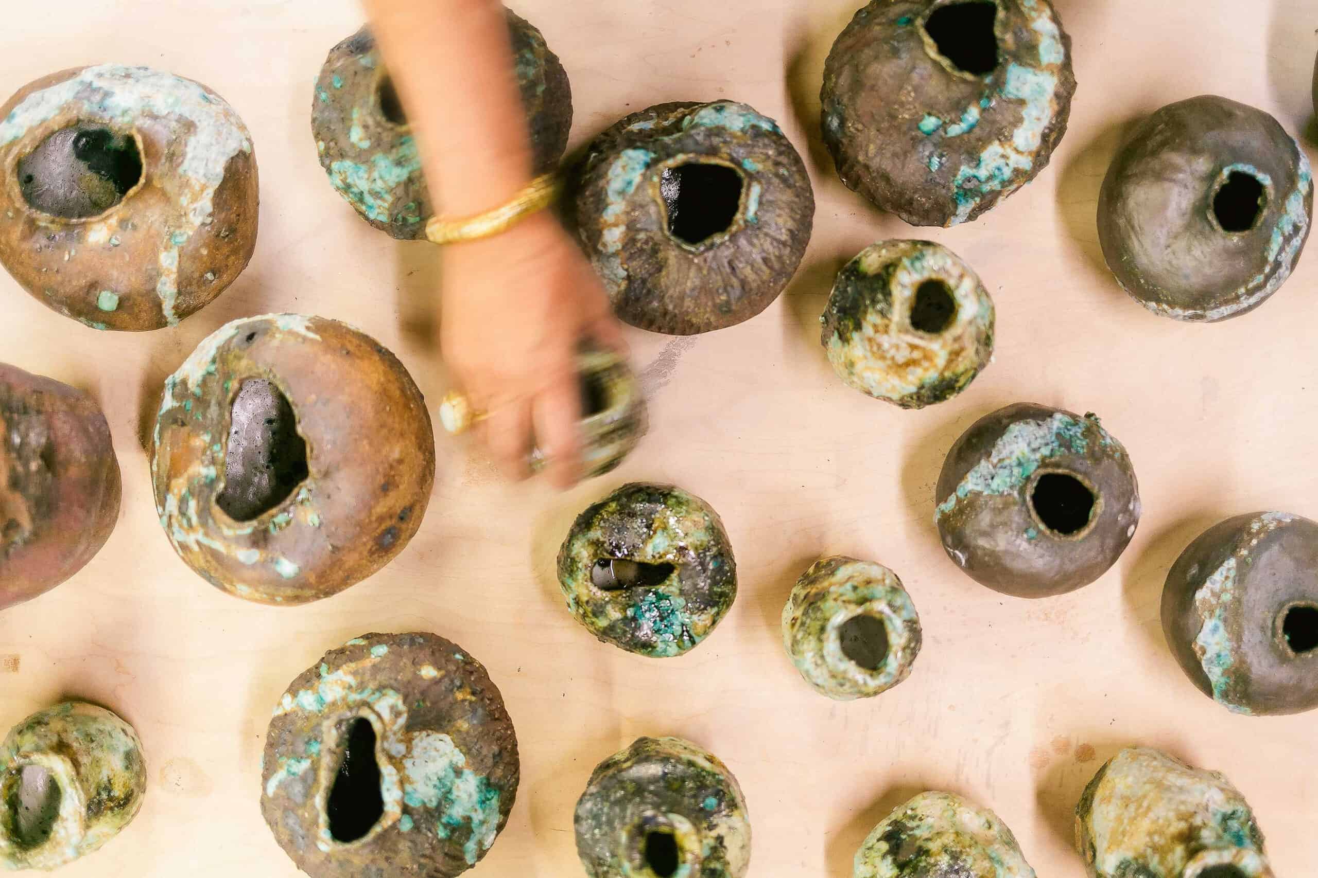 Iron-rich stoneware vessels are treated with handcrafted glaze of foraged minerals and other natural elements from her travels. Krahn’s father designed the gold ring with an opal from Australia, and offered gold, presented to him in a basket filled with nuggets by a friend in Papua New Guinea who owned a gold mine.
