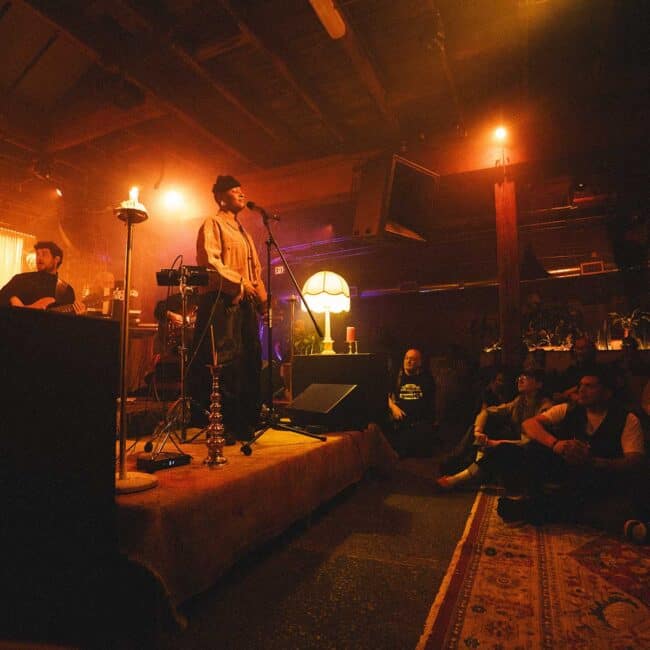 On the ITLF stage, Hailes met people’s eyes, introduced herself, and moved through the space as both headliner and someone sharing in the music. Designed to “erase that barrier and really make it a communal experience,” Living Room fostered a symbiotic exchange in which “the audience also has to make space for the performer.”